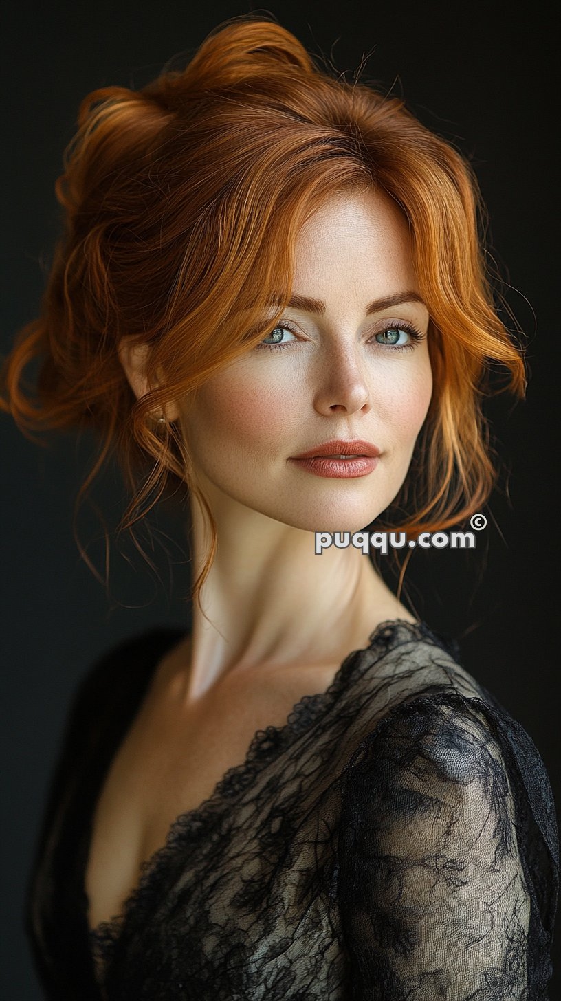 A woman with red hair styled in an updo, wearing a black lace top, looking directly at the camera with a soft expression.