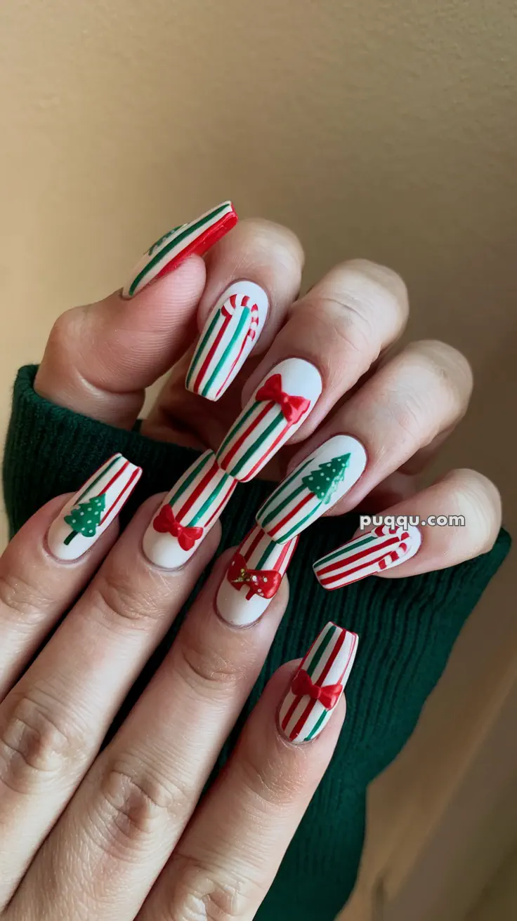 Holiday-themed nail art with red and green stripes, featuring Christmas trees, candy canes, and red bows.