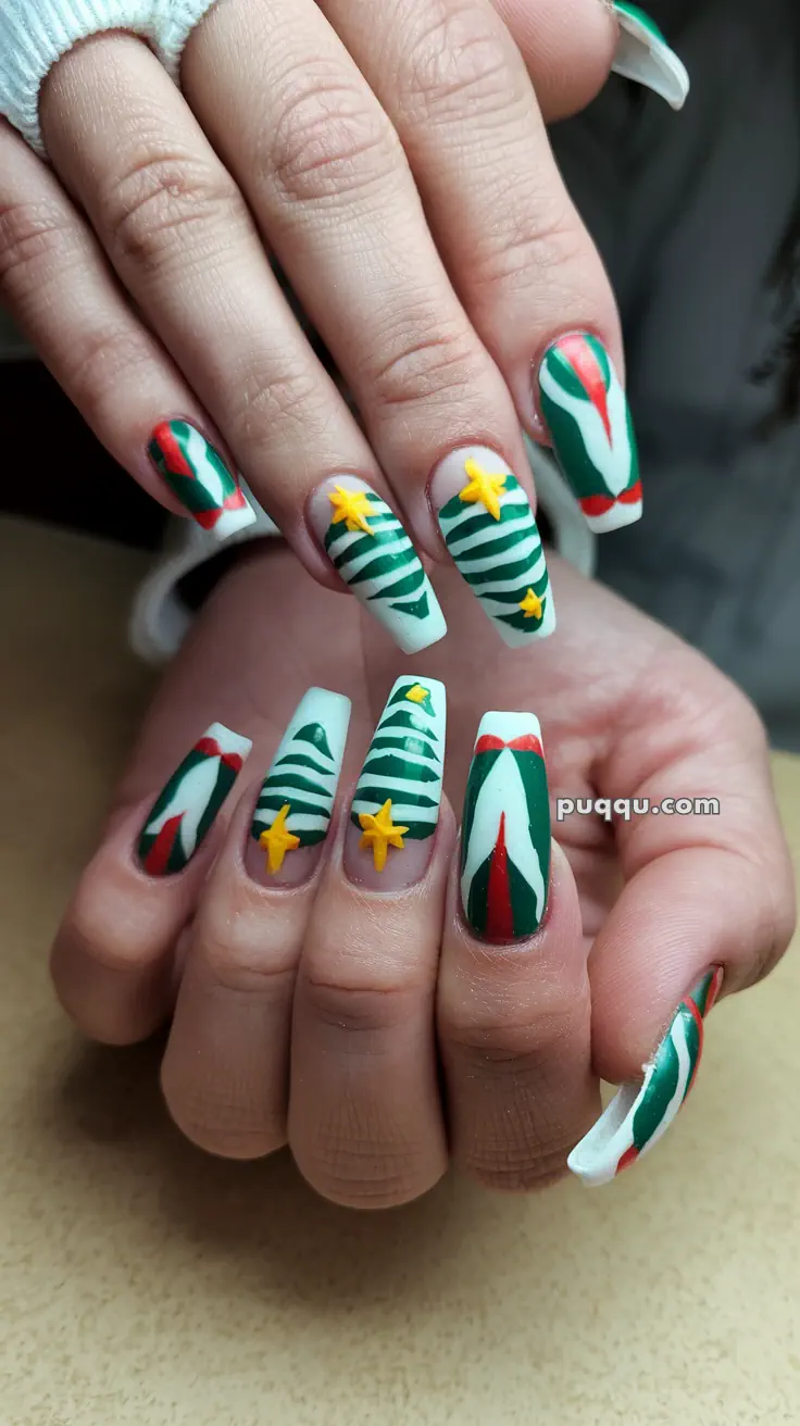 Festive nail art with Christmas tree designs, featuring green, red, and white colors with yellow star accents.