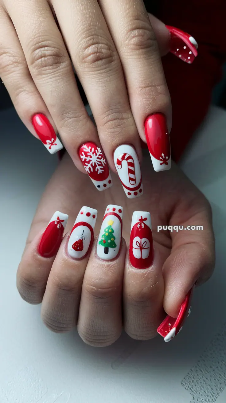 Close-up of hands with festive red and white Christmas-themed nail art, featuring designs of a snowflake, candy cane, Christmas tree, and gift box.