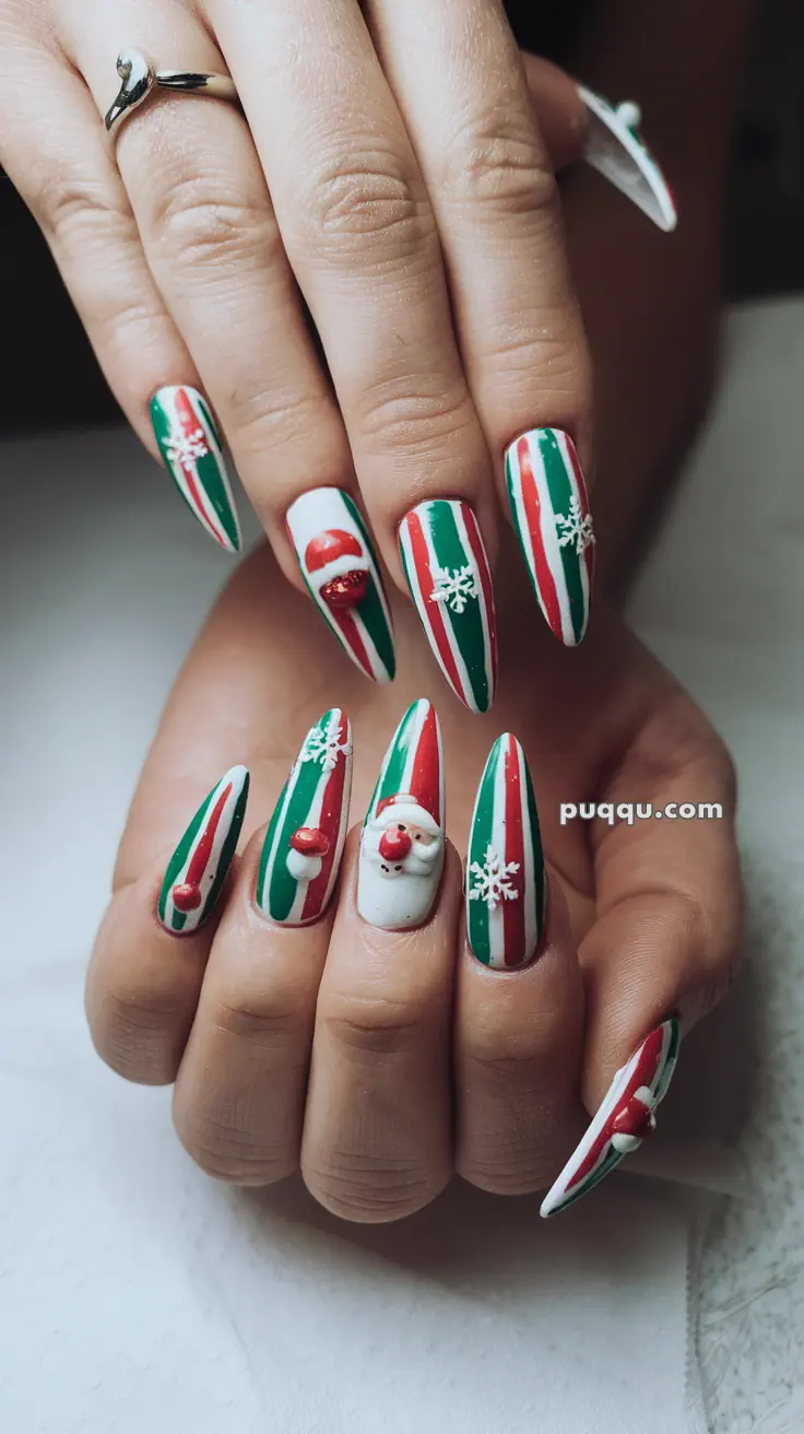 Christmas-themed nail art with red, green, and white stripes, featuring 3D decorations of Santa Claus, snowflakes, and presents.