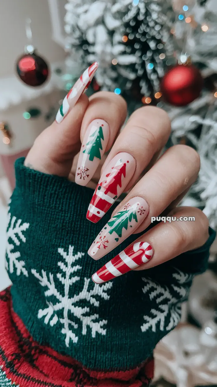 Festive Christmas-themed nail art with tree and candy cane designs near a decorated holiday tree.