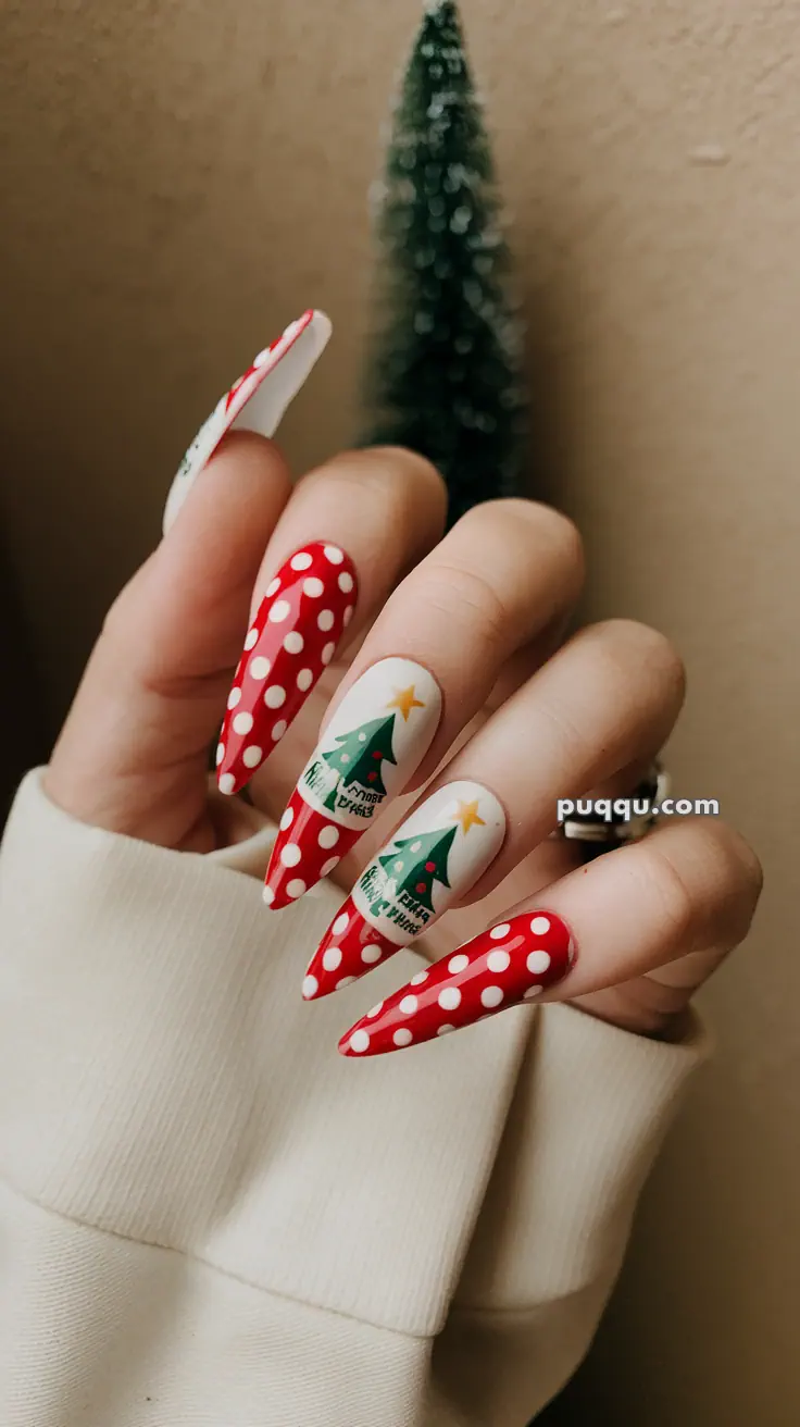 Hand with Christmas-themed nails, featuring red and white polka dots and Christmas tree designs.