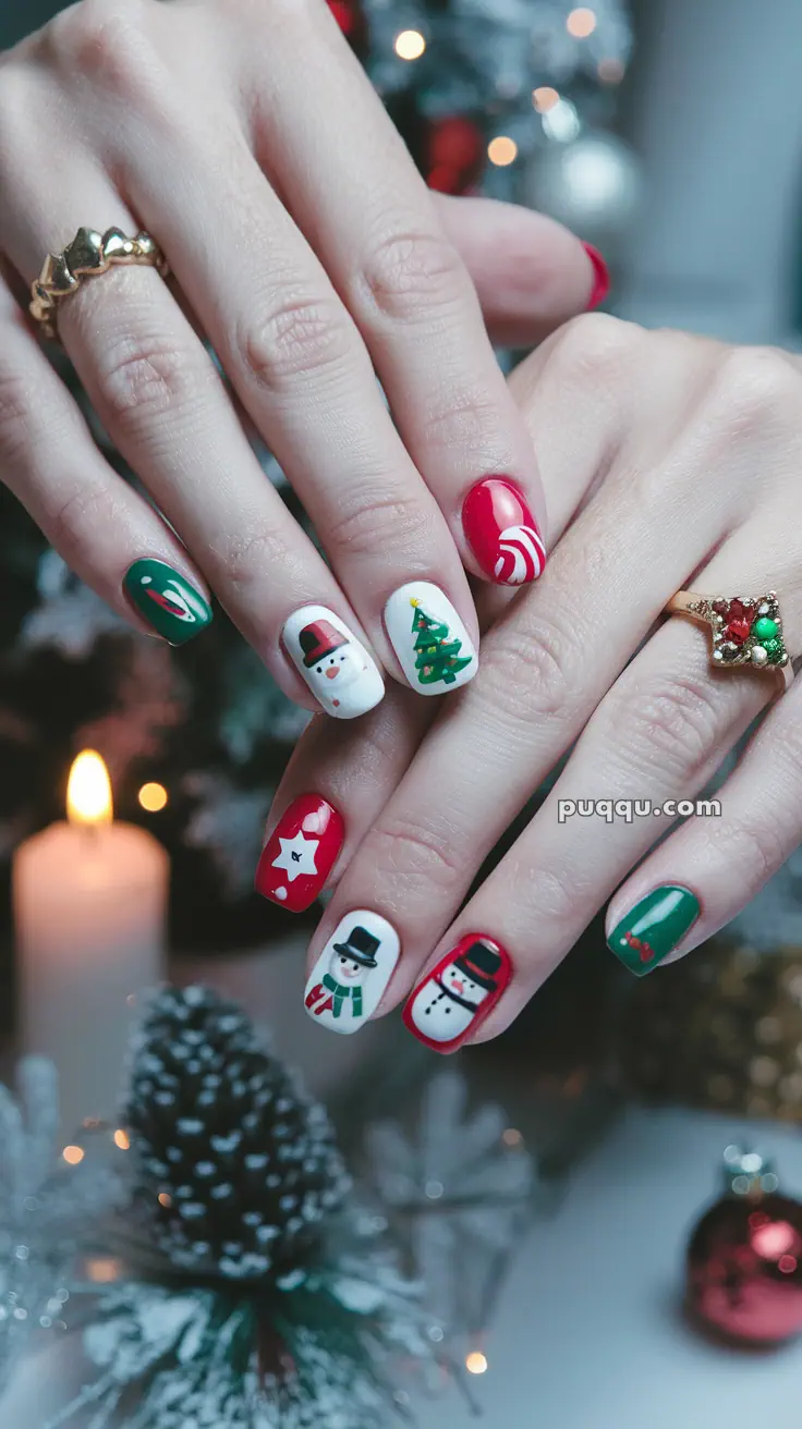 Hands with Christmas-themed nail art featuring snowmen, a Christmas tree, candy cane, and festive decorations.