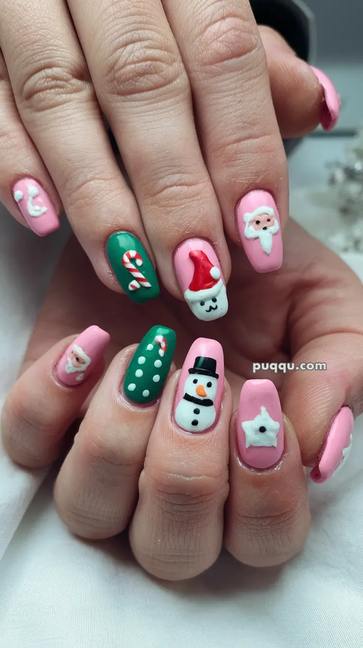 Close-up of festive nail art with pink and green nails featuring Santa Claus, a snowman, candy canes, and polka dots.