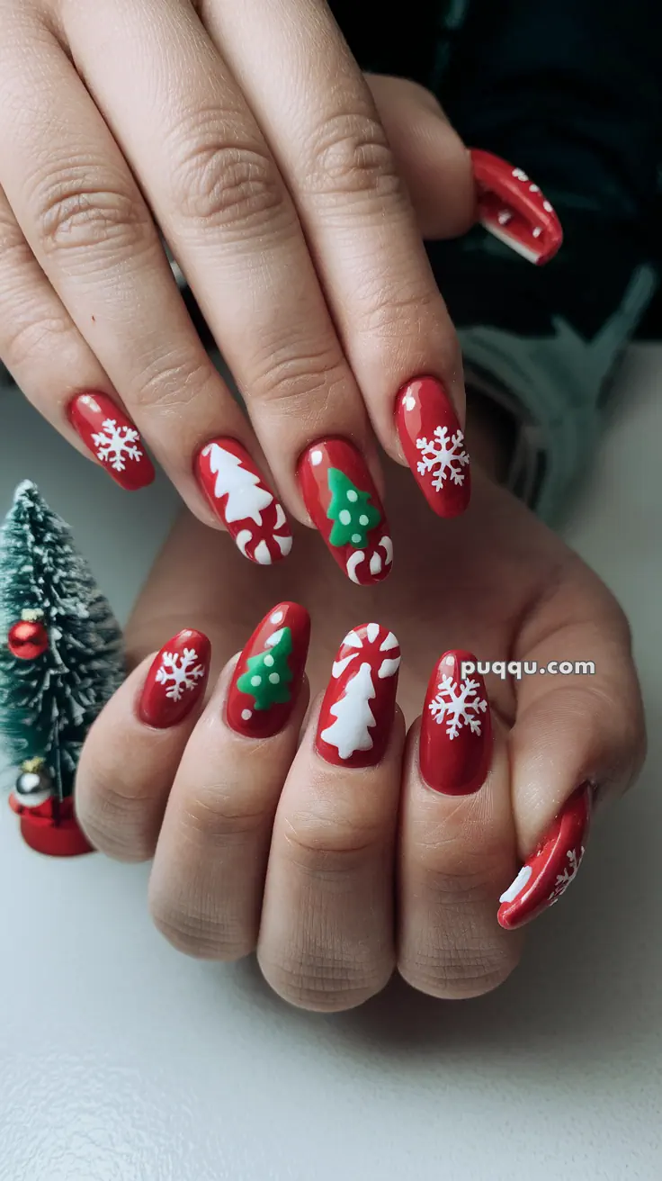 Red Christmas-themed nail art with snowflakes, Christmas trees, and candy cane designs.