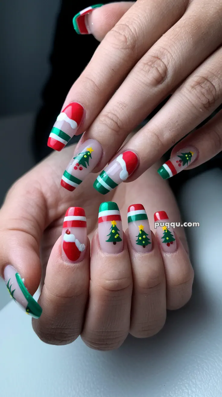 Festive Christmas-themed nail art with Santa hats, Christmas trees, and red-green stripes.