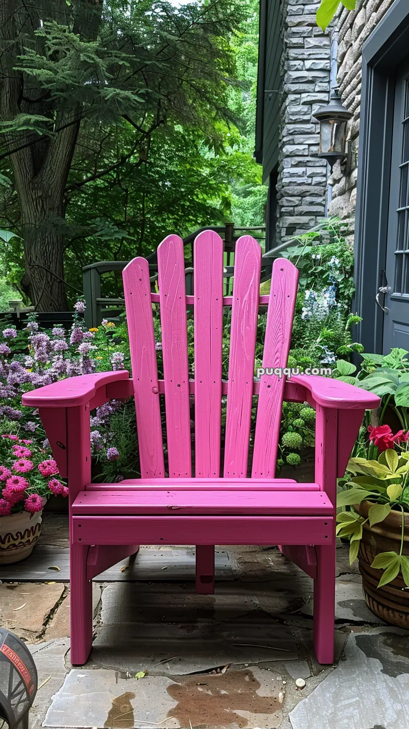 Pink Adirondack chair on a patio surrounded by lush greenery and flowers.